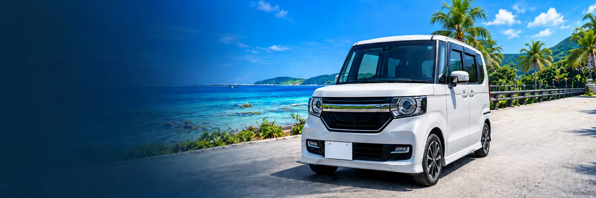 沖縄の海沿いの道に停まる白いホンダN-BOX|CAR LOVINGは沖縄本島全域で出張買取査定無料